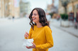 © bnenin - Girl with takeaway box laughing on the street.