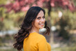 © bnenin - Beautiful girl looking at camera over the shoulder in light natural background, headshot.