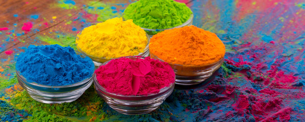 Holi color powder. Organic Gulal colours in bowl for Holi festival, Hindu tradition festive. Bright vibrant pigment closeup