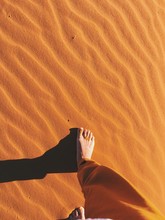 Woman Barefoot Walking In A Desert In Africa.