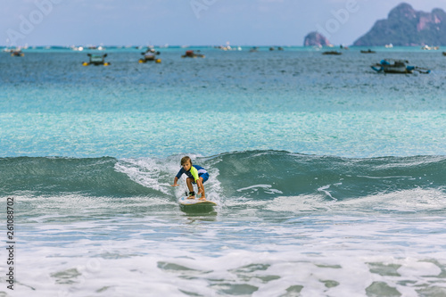 Little Boy Surfing Small Waves In Indonesia Buy This Stock