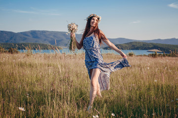 Beautiful woman enjoying field, pretty girl with long dark hair relaxing outdoor