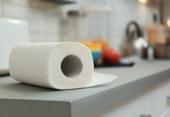 Sticker - Roll of paper towels on table in kitchen, space for text