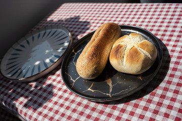 toasted bread placed in black plate,isolated on red patterned napkin