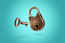 Levitating Closed Bronze Lock With Key On Azure Background