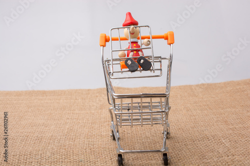 Pinocchio sitting on shopping trolley