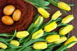  Naturalnie barwione jajka otoczone żółtymi tulipanami