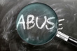Learn, study and inspect abuse - pictured as a magnifying glass enlarging word abuse, symbolizes researching, exploring and analyzing meaning of abuse, 3d illustration