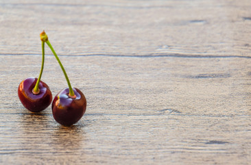 Cherry berries on a wooden background. Ripe red sweet cherry