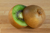 Fototapeta  - Kiwi fruit cut in half on a wooden board