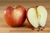 Fototapeta Sawanna - Half of and apple with one whole apple