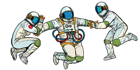 Wall Mural - three astronauts in space in zero gravity isolate on white background