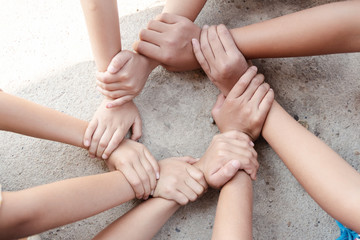 Group of children friends hands together joining concept