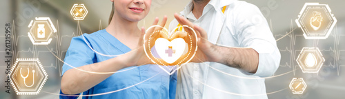 Cuadros en Lienzo Medical Healthcare Concept - Doctor in hospital with digital medical icons graphic banner showing symbol of medicine, medical care people, emergency service network, doctor data of patient health
