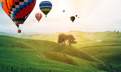 Wall Mural - Beautiful panoramic nature landscape of countryside mountains with colorful high hot air balloons festival in summer sky. Vacation travel panorama background.