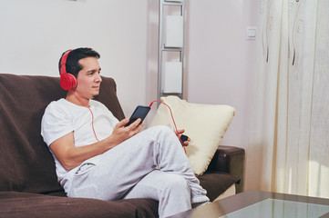 Wall Mural - young boy enjoys listening to music