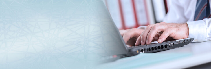 Businessman typing on laptop computer. panoramic banner