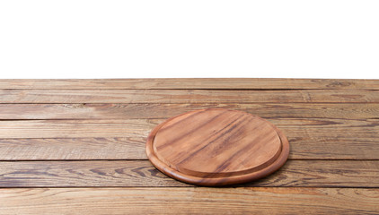 Wall Mural - Round pizza food cutting board on brown wooden table isolated on white background. Wood tray plate and table top view. Empty copy space. Selective focus. Banner