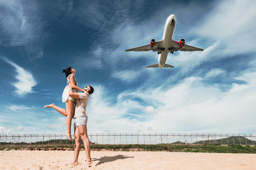 Wall Mural - Beautiful couple on having fun on the beach. Happy couple on vacation. Honeymoon trip. Honeymoon lovers. Man and woman traveling. Tourists on vacation. Vacation at sea. Wedding travel. Mai Khao Beach