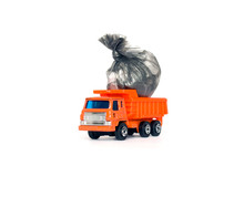 Toy Garbage Truck With Garbage Bags Isolated On White Background