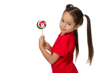 Wall Mural - Beautiful cute little child girl with sweet candy lollipop isolated on white background