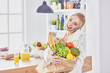 © lenetsnikolai - Young woman holding grocery shopping bag with vegetables Standi