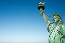 Close Up Of The Statue Of Liberty In New York, USA. Blue Sky Background With Copy Space