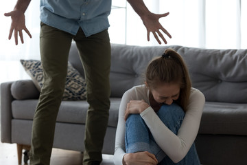 unhappy frightened woman crying, aggressive man shouting, emotional abuse