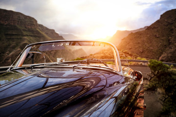 Summer car on road and sunset time in mountains. 