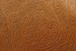 A floral light tan embossed leather background texture.