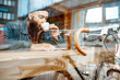 © rh2010 - Stylish man enjoying a coffee drink while sitting at the cafe near the window with retro bicycle. View through the window with urban reflection