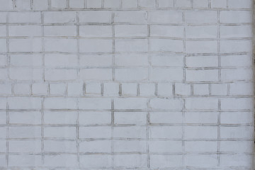 Wall Mural - An old brick uneven wall painted unevenly white. Best for backgrounds