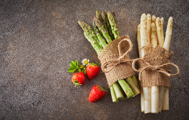 Two bundles of fresh white and green asparagus