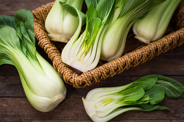 Canvas Print - Pak choi in the basket on the wooden table
