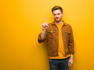 Wall Mural - Young redhead man showing number one