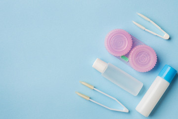 Wall Mural - Contact lenses, tweezers and a container for storing lenses, containers for solution and moisturizing drops. Close up. Selective focus.