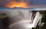 Fototapeta  - Victoria Falls sunset with rainbow, Zambia