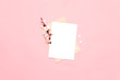 Paper blank and spring flowers on pink background. Mockup with flowers.