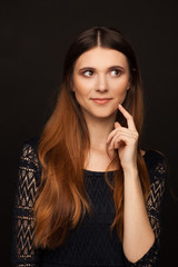 Wall Mural - Portrait of a beautiful woman with straight long hair and interesting emotion. Studio photo session