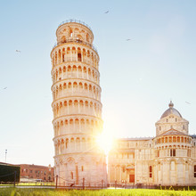 Pisa Leaning Tower And Cathedral Basilica At Sunrise, Italy. Travel Concept