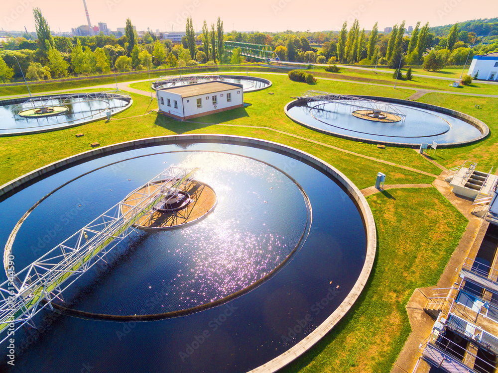 Aerial view to sewage treatment plant. Grey water recycling. Waste management in European Union. - obrazy, fototapety, plakaty 