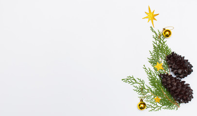 Christmas composition. Christmas gift, knitted blanket, pine cones, fir branches on wooden white background. Flat lay, top view