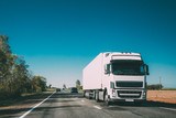 Fototapeta Uliczki - Truck On Country Road. Tractor Unit, Prime Mover, Traction Unit In Motion On Countryside Road In Europe. Business Transportation And Trucking Industry Concept