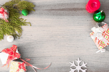 top view on nice christmas gift wrapped in white gift paper, tree decorations on white wooden white 