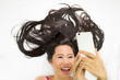 © Nutt - Closeup portrait of asian women  lying on ground with black long hair. acting wow , and plying phone.