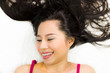 © Nutt - Closeup portrait of happy asian women  lying on ground with black long hair. acting smile, fun,