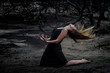 © Macia Puiggros/ADDICTIVE STOCK - Side view of young ballerina in black wear posing on land between dry woods