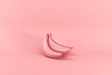 Bunch Of Bananas Painted In Pink Isolated On Pink Background. Minimal Fruit Idea Concept.
