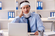 © Elnur - Young injured male employee working in the office