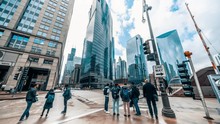 4K UHD Time-lapse Of Road Intersection In Business District Chicago, USA. People Walking And Car Traffic Transport Across Streets. American City Life Concept